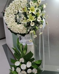 A Radiance Rose white funeral Wreath